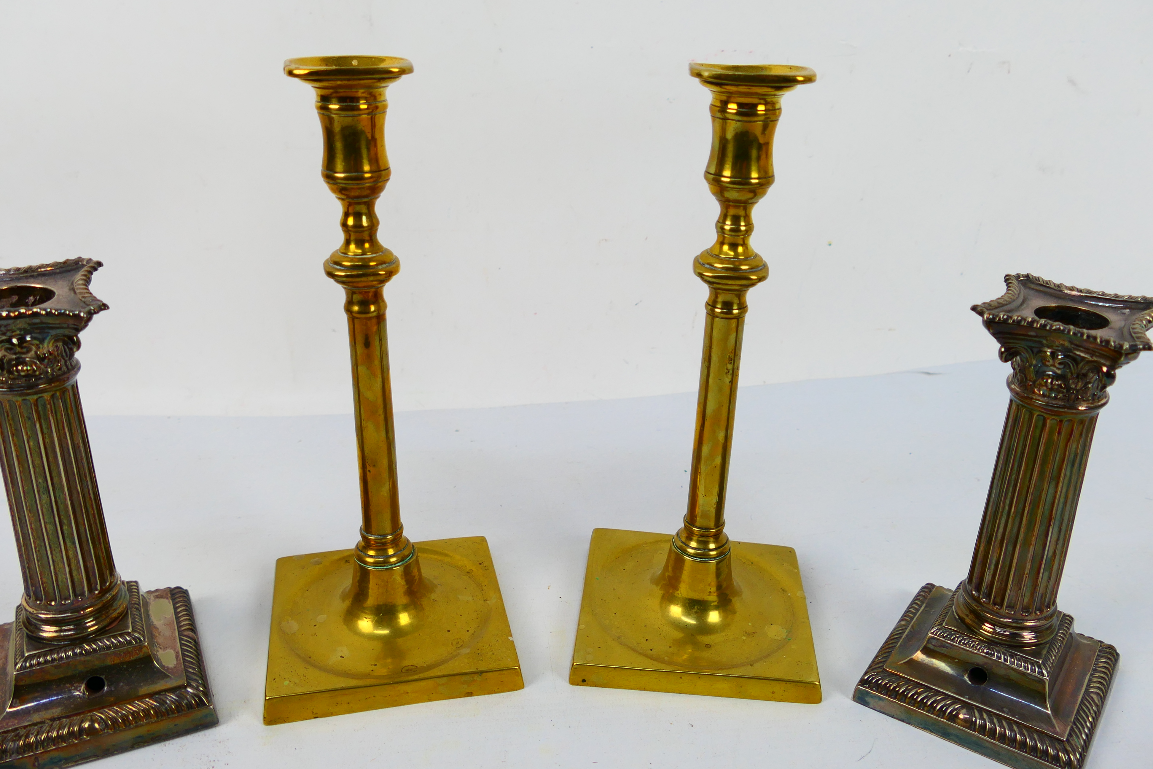 Two pairs of candlesticks comprising a pair of silver plated Corinthian column examples and a brass - Image 4 of 4