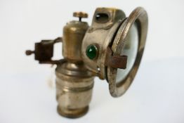 A Powell & Hanmer (P&H) Panther acetylene or carbide bicycle lamp with 3" convex clear glass lens