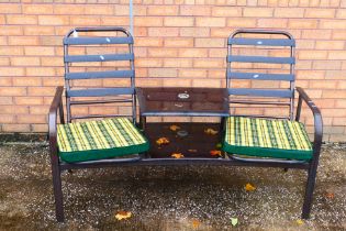 A two seat garden love seat and table, approximately 95 cm x 155 cm x 76 cm.