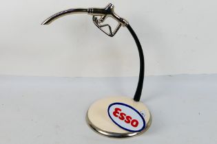 A chrome model of a petrol pump nozzle with cast metal ESSO plaque to the base, 33 cm (h).