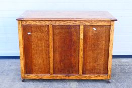 An oak blanket chest with three panel front and hinged top, approximately 68 cm x 95 cm x 47 cm.