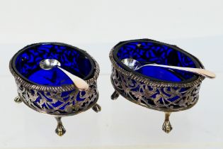 A pair of Edwardian silver open salts with blue glass liners, Birmingham assay 1903,