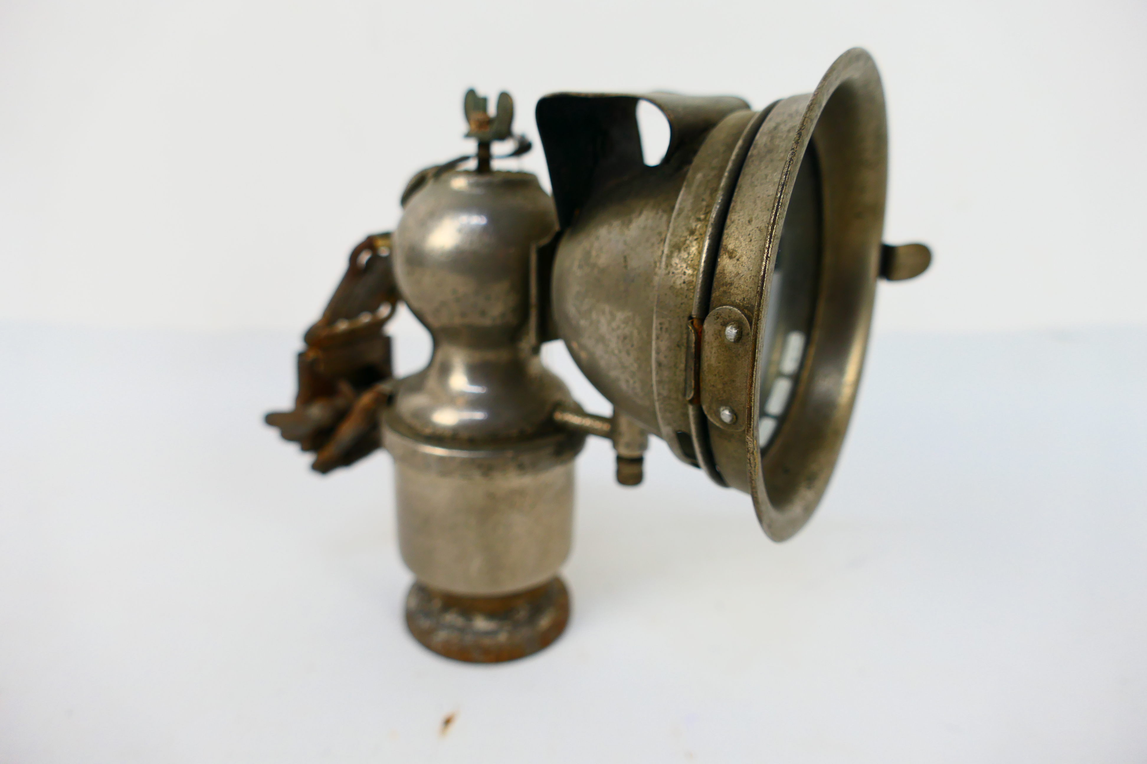 A vintage acetylene or carbide bicycle lamp with 2¾" clear glass lens, approximately 15 cm (h).