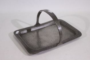 Liberty & Co - A Tudric pewter tray with scroll decorated rim and arch handle,