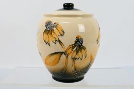 Moorcroft Pottery - A Moorcroft Pottery vase and cover decorated in the Coneflower pattern,