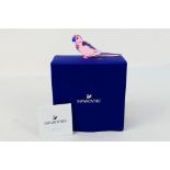 Swarovski - A boxed crystal figure from the Jungle Beats collection, Pink Parakeet Cha Cha,