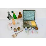 A quantity of perfume bottles, predominantly glass and cased flatware.