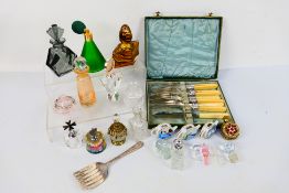 A quantity of perfume bottles, predominantly glass and cased flatware.