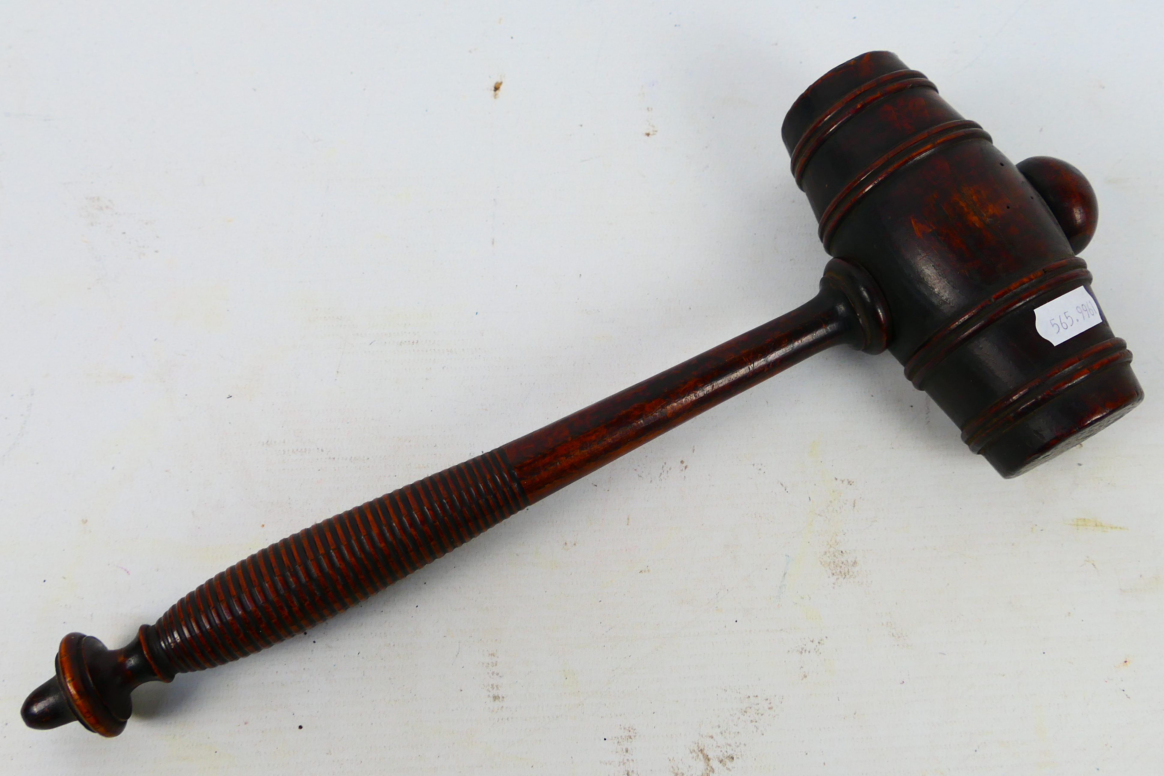 A large mahogany gavel with turned handle, approximately 37 cm (l).