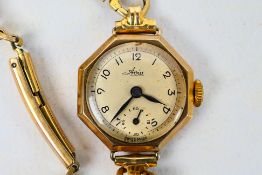 A lady's 9ct gold cased wrist watch on 1/20 12k Gold Filled bracelet.