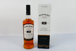 A 700ml bottle of Bowmore 12 year old, 40% abv, contained in carton.