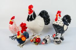 A quantity of ceramic models in the form of hens and cockerels, largest approximately 34 cm (h).