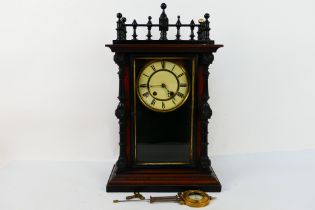 An unusual Continental 8-day bell striking mantel clock in a decorative polished and ebonised wood