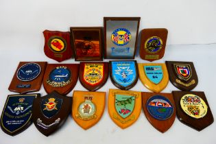 A collection of commemorative wooden shield plaques to include squadron, NATO AWACS,