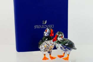 Swarovski - A boxed crystal group depicting a pair of Atlantic Puffins, approximately 5 cm (h),