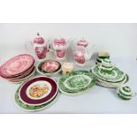 A collection of ironstone dinner and tea wares in red and white and green and white.