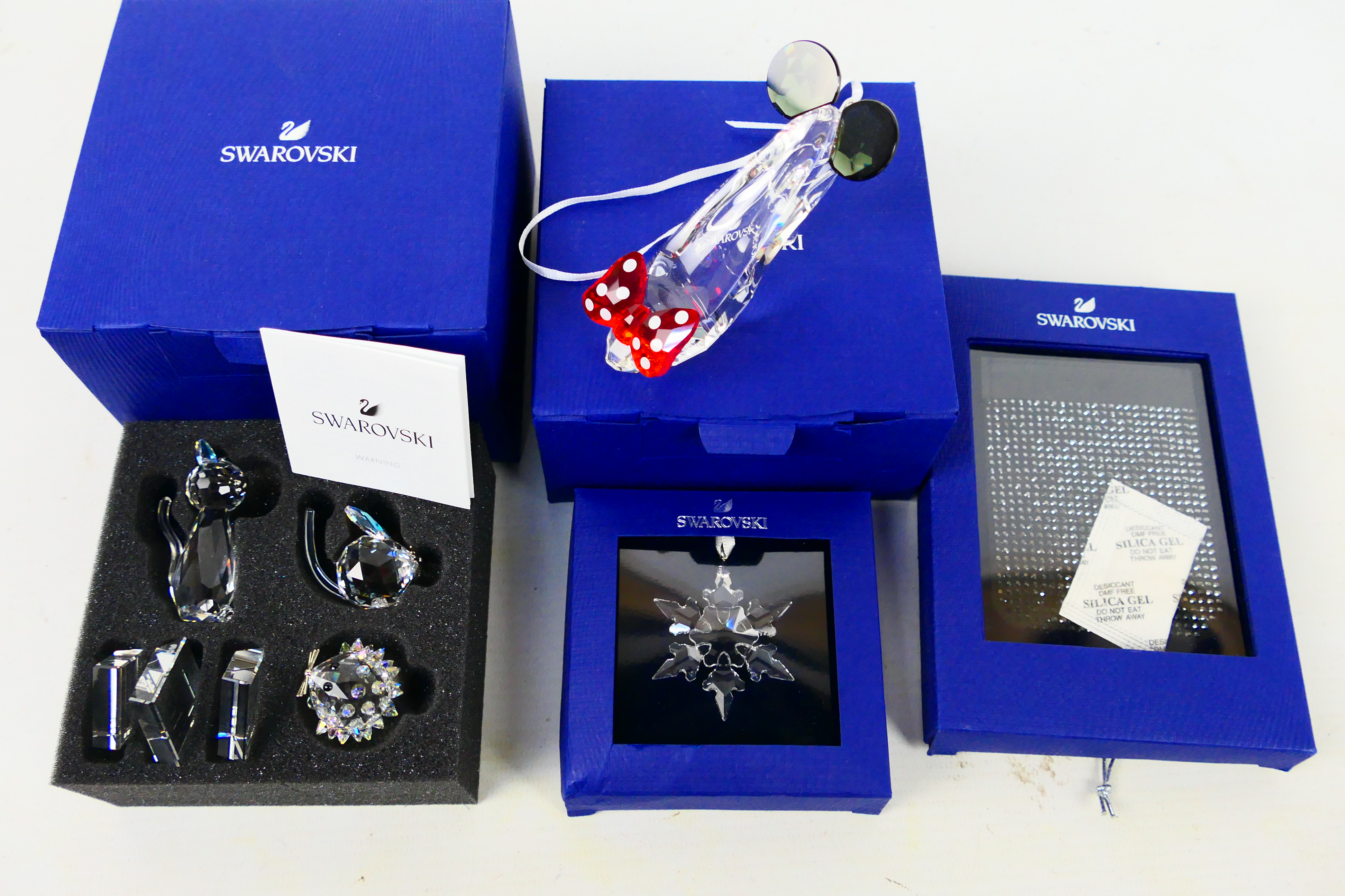 Swarovski - A collection of boxed pieces to include a Disney Minnie Mouse Inspired Shoe ornament,