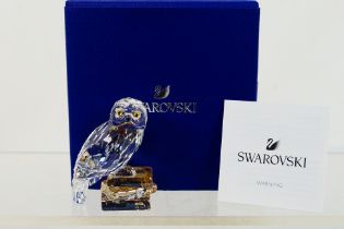 Swarovski - A boxed Harry Potter model depicting Hedwig the snowy owl sat atop a stack of books,