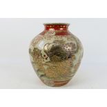 An Oriental crackle glaze vase of ovoid form with gilt decoration of a peacock amidst foliage,