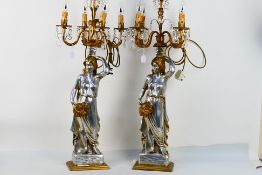 A pair of figural stem table lamps having five lights, approximately 92 cm (h). [2].