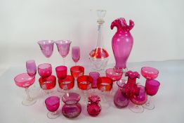 A lidded decanter and five drinking glasses decorated with grape vines, and nine further wine,