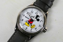 A contemporary Ingersoll Mickey Mouse Disney wrist watch on grey leather strap.