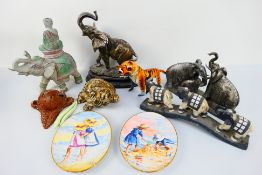 A collection of animal figures to include elephants,