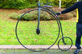 A Penny Farthing or ordinary bicycle with moustache handlebars, slotted cranks, spoon brake,