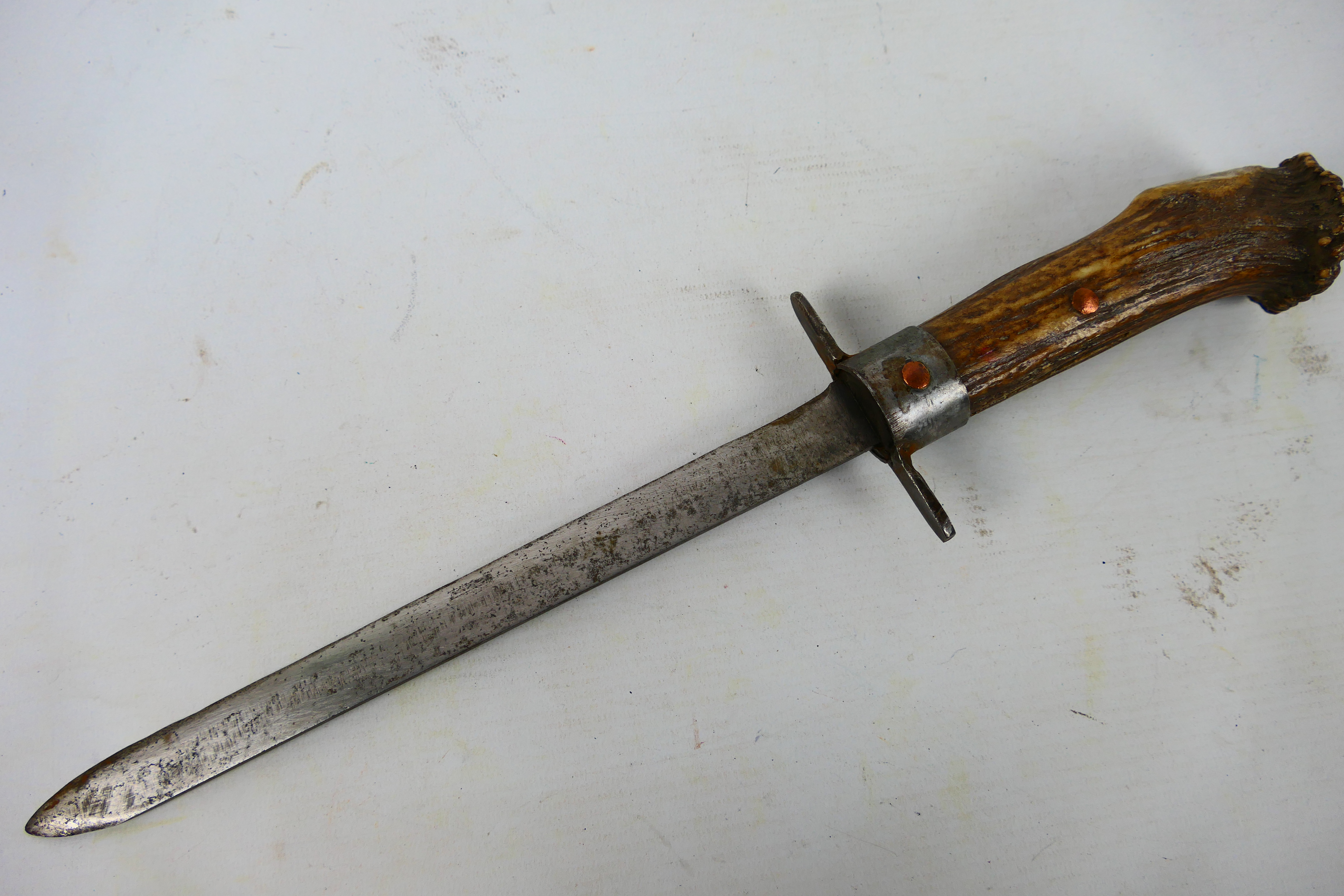 An antique staghorn hilt knife with 25 cm (l) single edge blade, 40 cm (l) overall.