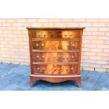 A bow front chest of two over three drawers, raised on outswept supports,