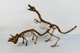Two metal dinosaur sculptures by Tony Pusey, also known as Dinosculptor,