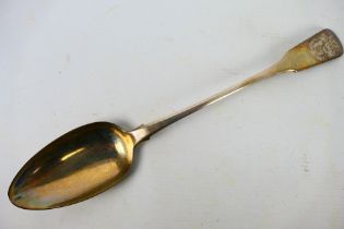 A George III silver basting spoon with engraved coat of arms to the terminal, London assay 1818,