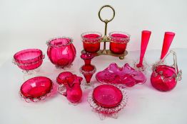 A pair of cranberry glass dishes with clear glass frilled decorated to the upper rims 9.