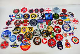 A collection of world air force related cloth and similar patches and stickers to include Austrian,