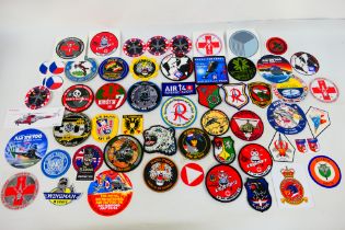 A collection of world air force related cloth and similar patches and stickers to include Austrian,