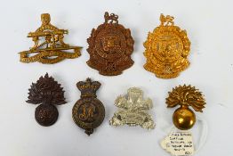 A collection of military badges to include Royal Fusiliers, Queensland Medical Department and other.