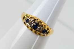 An 18ct yellow gold sapphire and diamond set ring, size P+½, approximately 2 grams.