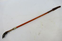 An antique riding crop with bird foot handle and white metal collar, 57 cm (l).