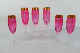 A set of six Italian Champagne flutes having clear glass stems,