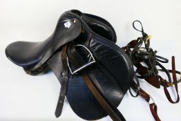 A black leather general purpose saddle.