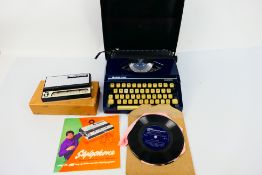 A vintage Stylophone and a portable typewriter. [2].