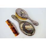 Three late Victorian silver backed dressing table items comprising hand mirror, brush and comb,