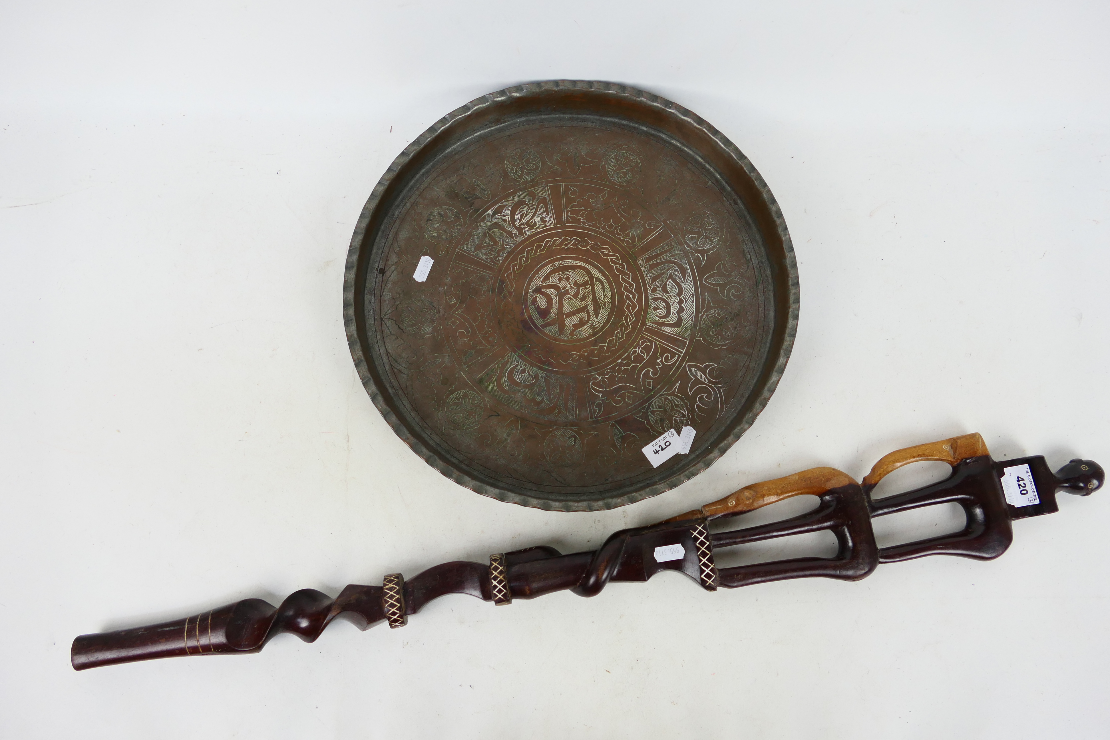 Ethnographica - An African tribal carving, 88 cm (l) and an Islamic copper dish, 40 cm (d). [2].