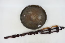 Ethnographica - An African tribal carving, 88 cm (l) and an Islamic copper dish, 40 cm (d). [2].