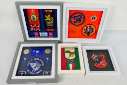 A collection of aviation related patches housed in five framed displays,