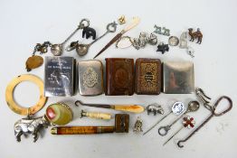 Mixed collectables to include vesta cases, matchbox cover, baby's rattle, white metal charms,