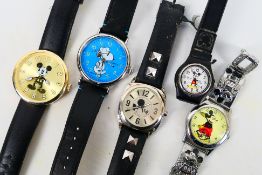 A collection of Mickey Mouse and Snoopy wrist watches.