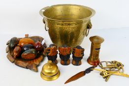 Brassware and treen to include brass counter top bell, carved wood fruits,