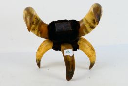 An unusual antique table snuff mull formed from cow horns, approximately 29 cm.