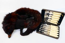 Cased flatware and a fur stole.